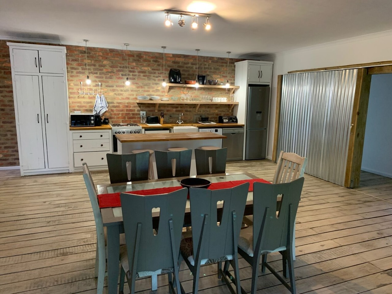 Dining table for eight with open-plan kitchen behind