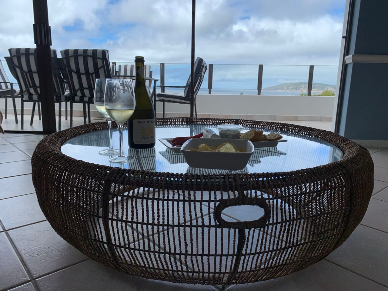 Balcony lounge set up for sundowners overlooking the bay